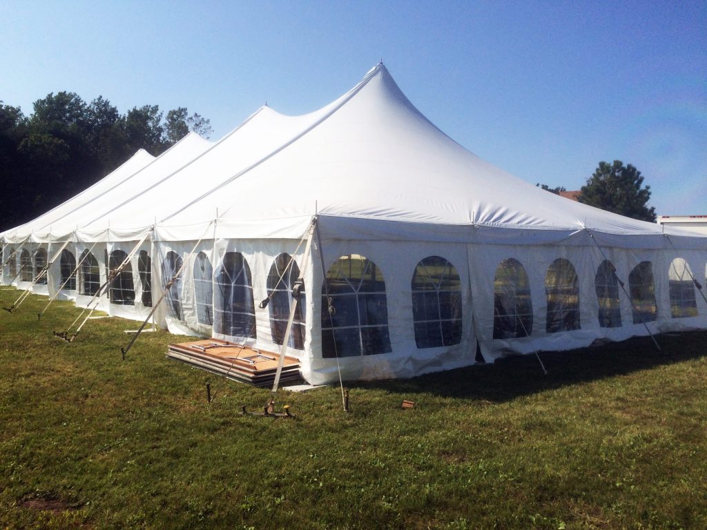 Outside of 40' x 100' rope and pole wedding tent with French window sidewall