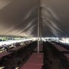 Under 40' x 120' rope and pole tent with tables and chairs