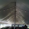 Under of 40' x 100' rope and pole wedding tent with French window sidewall and Edison lights