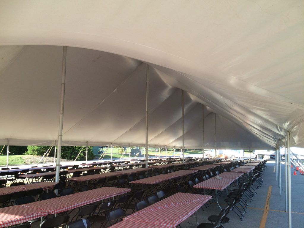 Under the 40' x 120' rope and pole tent with tables