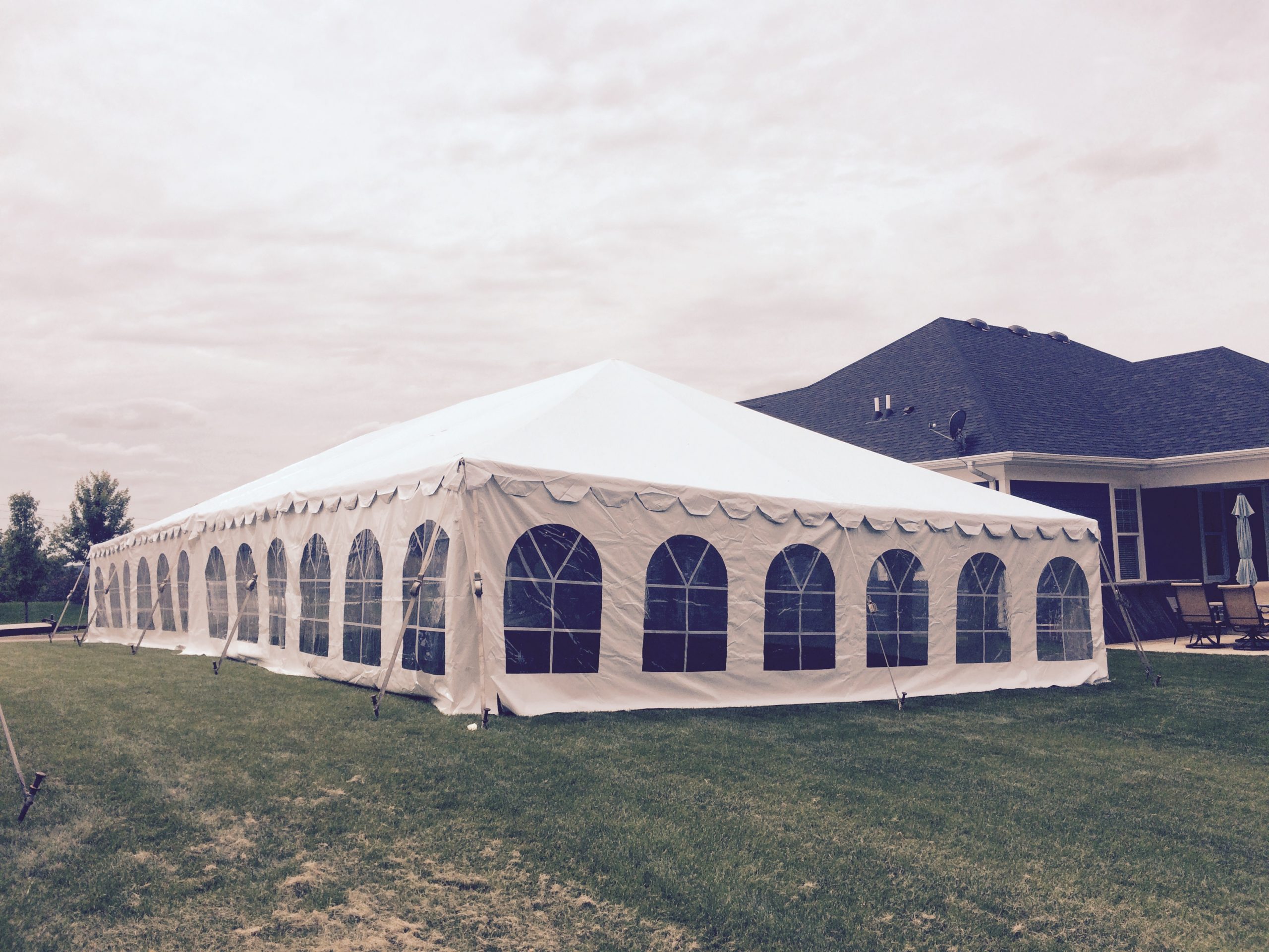 Back of 30' x 60 frame tent in side yard for wedding reception in Dubuque, Iowa in side yard