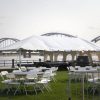 Frame tent with tables and chairs at 2015 River Roots Quad Cities Music and Rib Fest