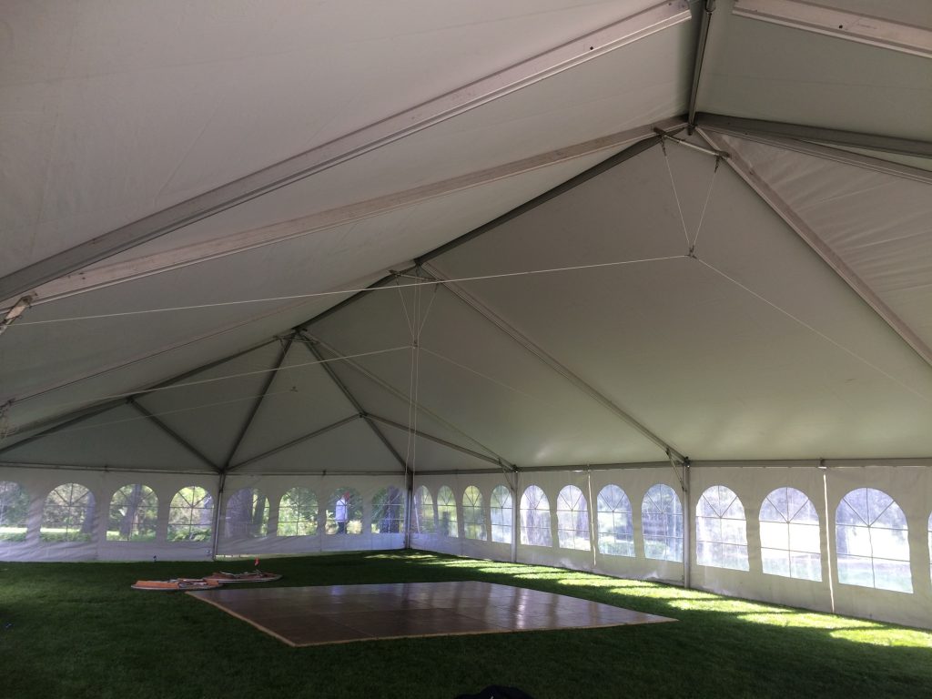 Under the 40' x 80' wedding reception tent at Oakwood Country Club in Coal Valley Illinois with dance floor