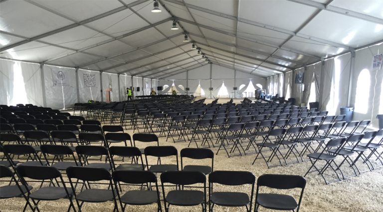 Temporary indoor onsite seating for 800 people with stage, catering, heating & lighting