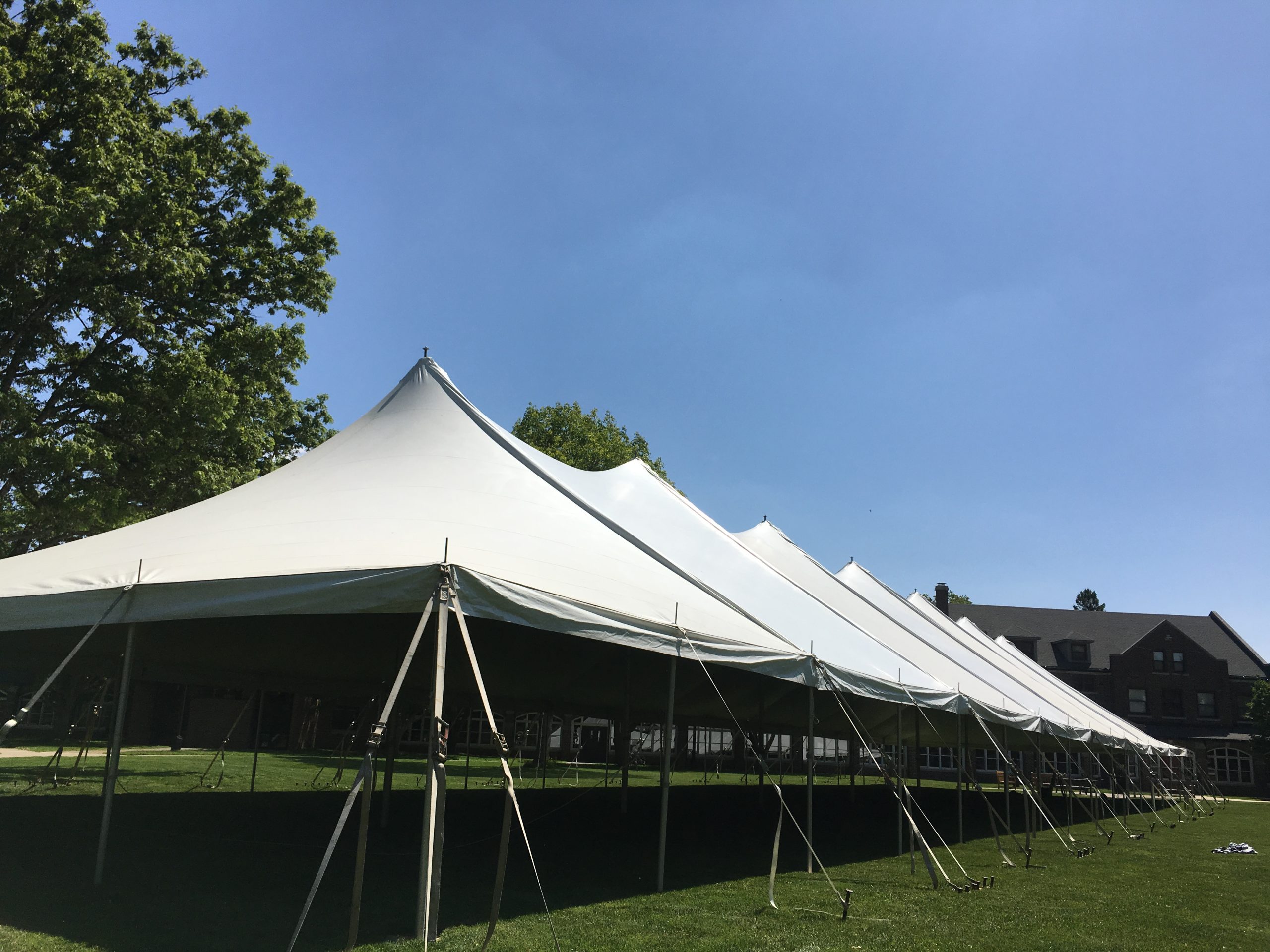 Outside of 40' x 160' rope and pole tent for a commencement ceremony at Grinnell College