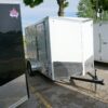 Right side of White 6'x10' enclosed cargo trailer Vin Number 2803 next to other trailers