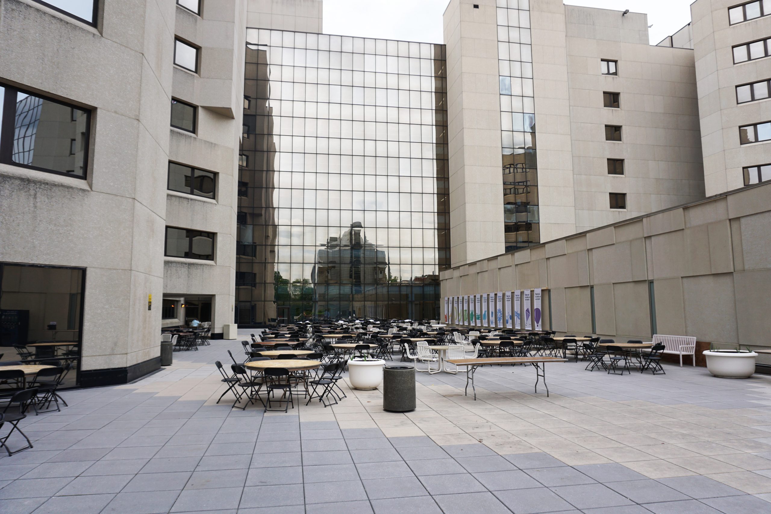 Tables and chairs at University of Iowa Hospitals and Clinics courtyard image from ground