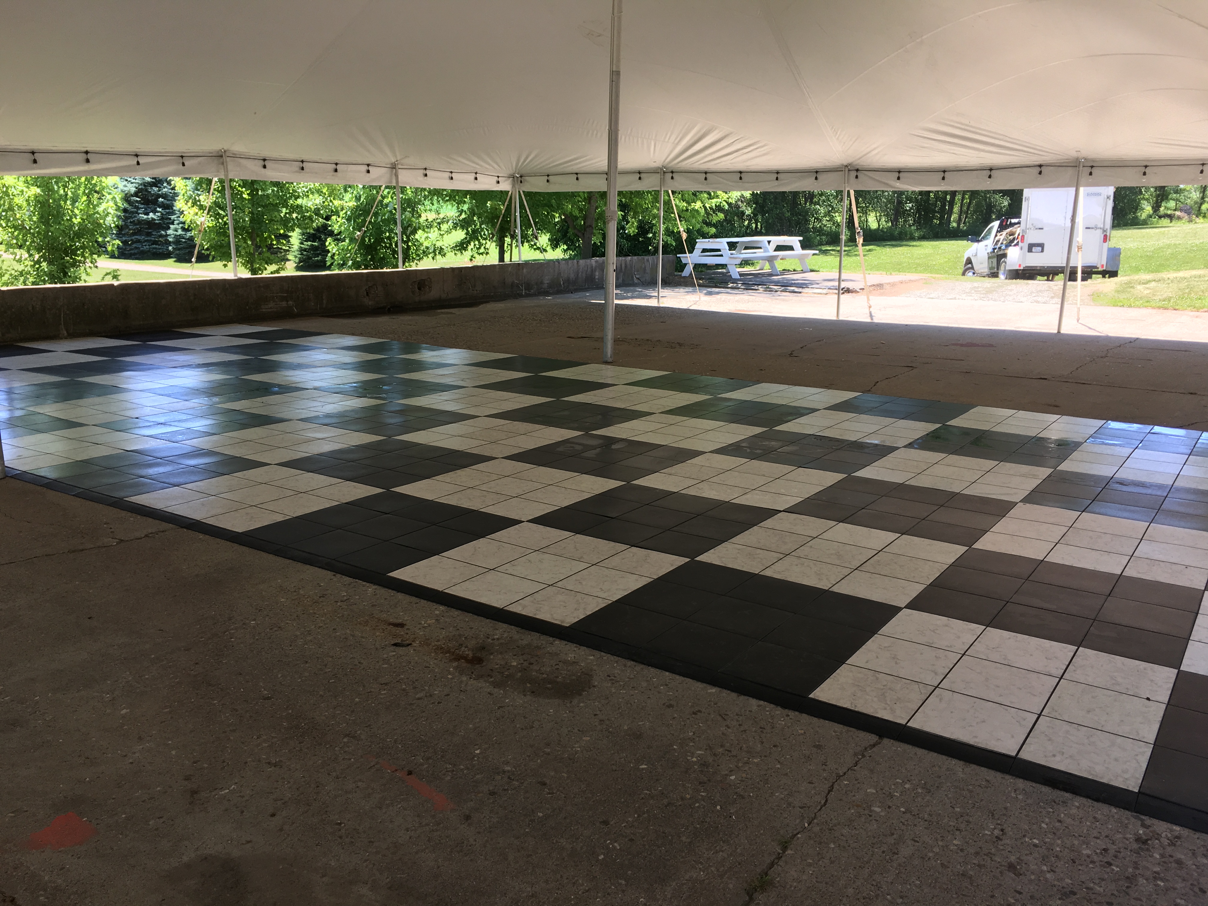 Dance flooring under 40'x60' Rope and Pole Tent for an outdoor wedding reception in Columbus Junction, IA