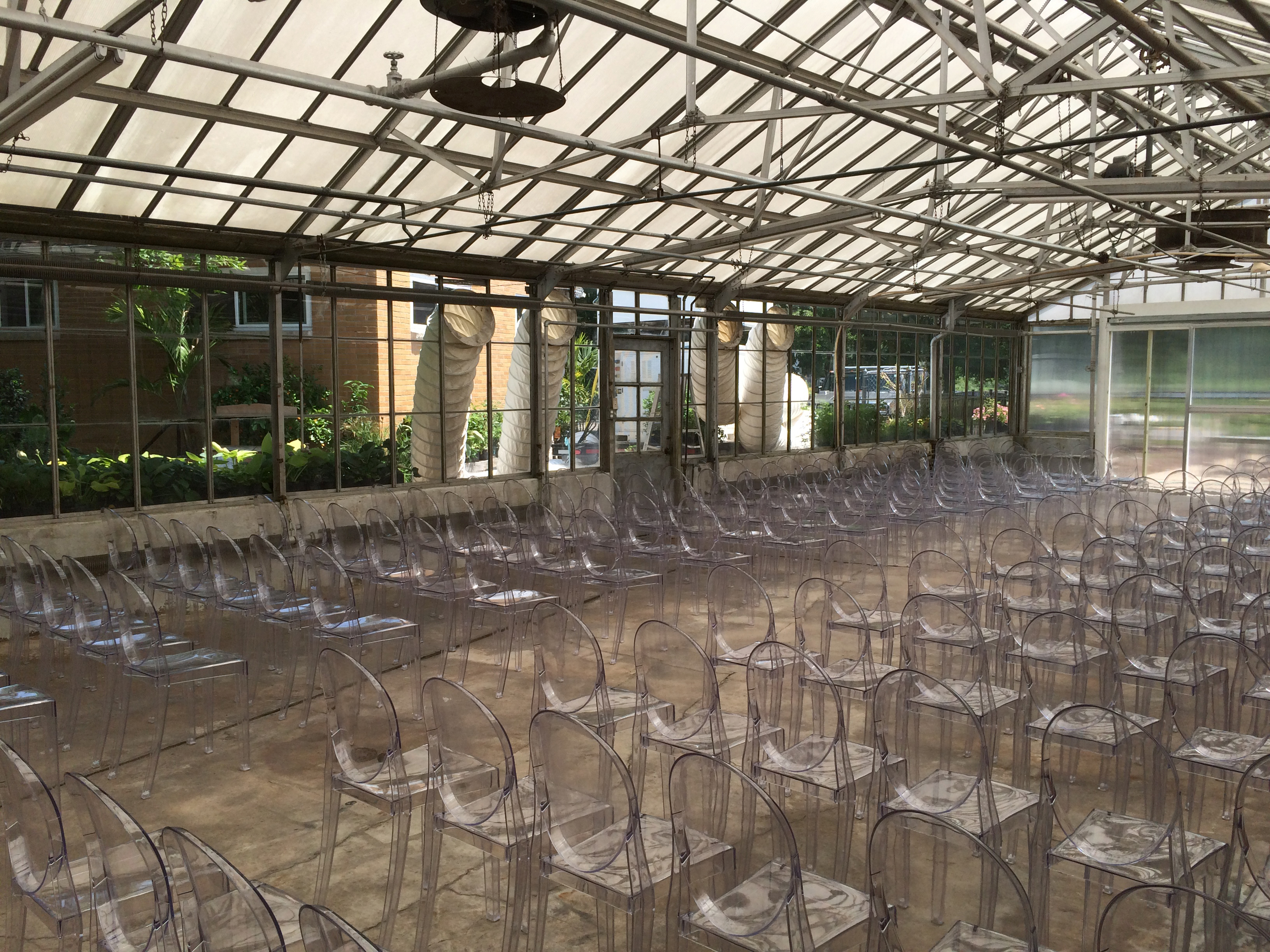 Inside the greenhouse with chairs for wedding. See Air Conditioning ducts in windows