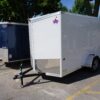 Left front of 6' x 10' white single axle enclosed trailer [sn2852]