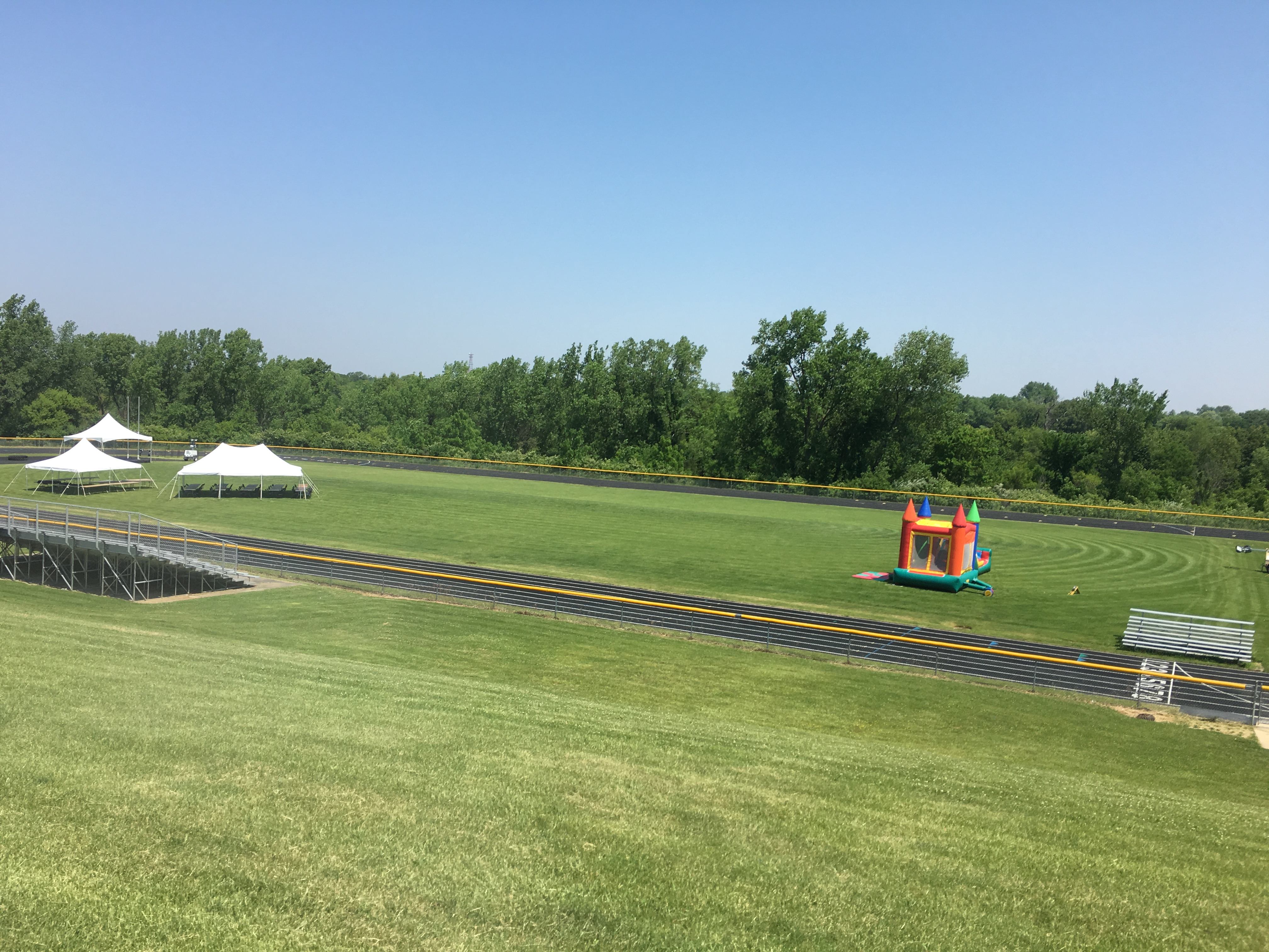 Middle of Relay for Life running track with tents and bounce house