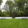Back view of 200 White Padded Resin Chairs for an outdoor wedding in Wapsipinicon Park in Anamosa, IA