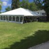 Corner of 40' x 60' hybrid tent with French Window side wall on two sides used for an outdoor wedding reception