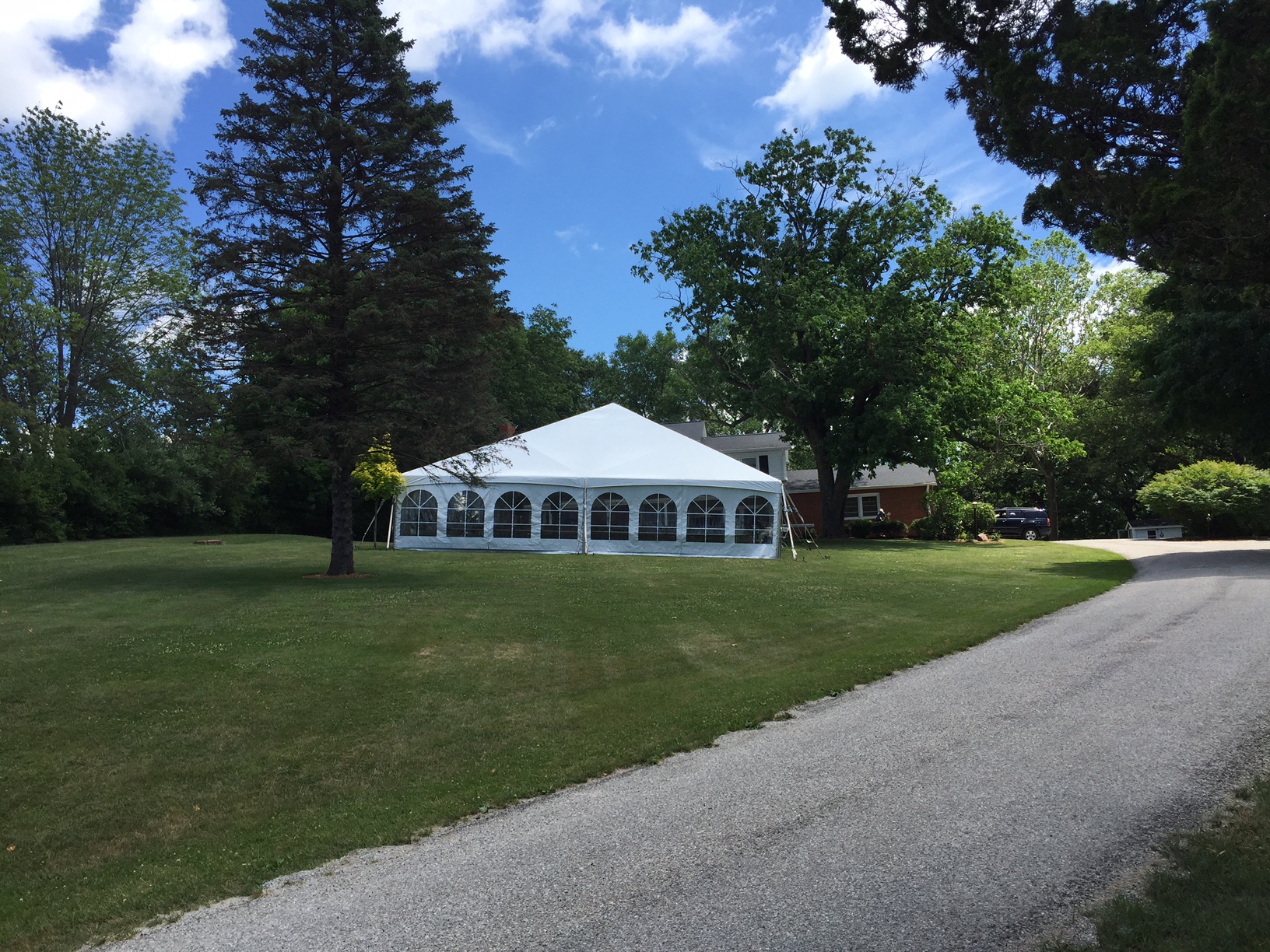 Front of 40' x 60' hybrid tent with French Window side wall on two sides used for an outdoor wedding reception