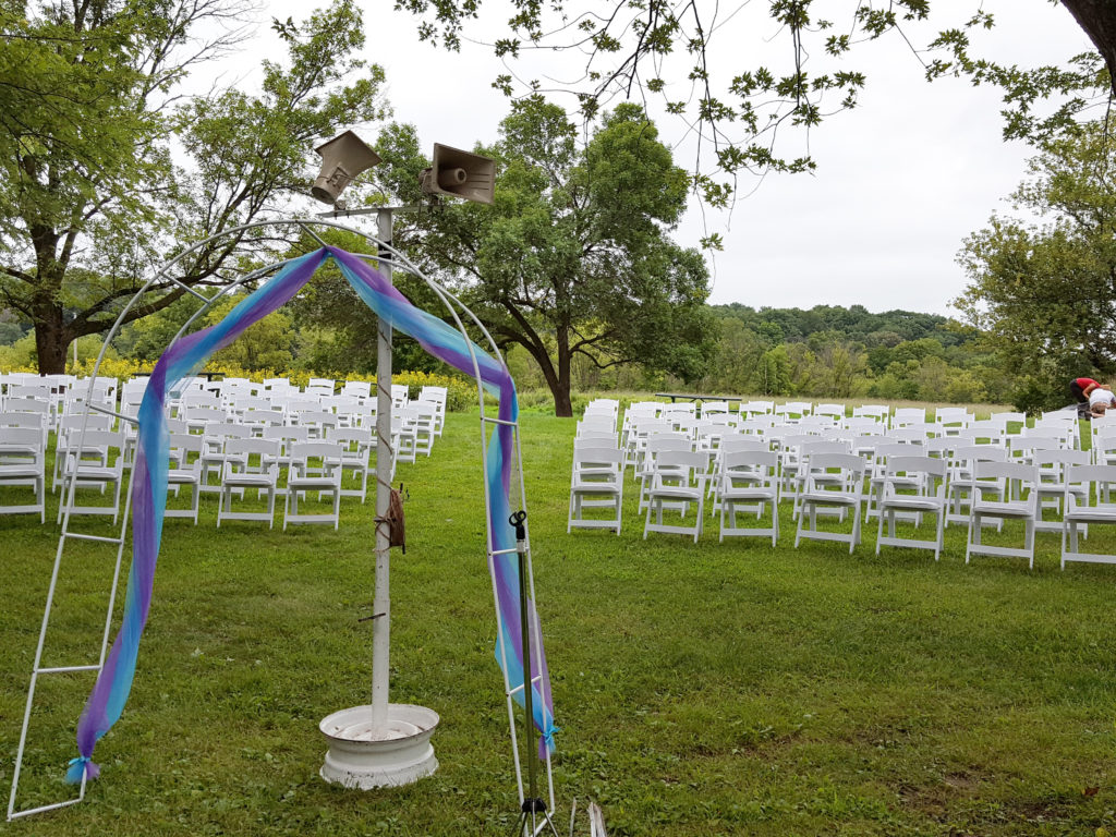 Front view of 200 White Padded Resin Chairs for an outdoor wedding in Wapsipinicon Park in Anamosa, IA