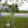 Front view of 200 White Padded Resin Chairs for an outdoor wedding in Wapsipinicon Park in Anamosa, IA