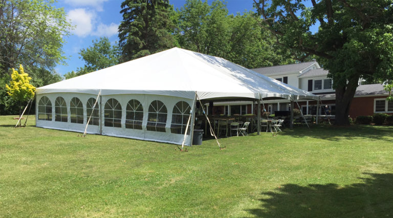 Outdoor wedding reception set up with 40′ x 60′ hybrid tent in Iowa