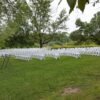 Side view of 200 White Padded Resin Chairs for an outdoor wedding in Wapsipinicon Park in Anamosa, IA