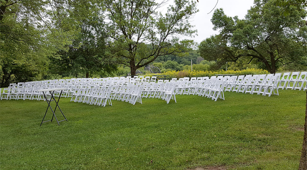 White wedding chairs outside at Wapsipinicon State Park