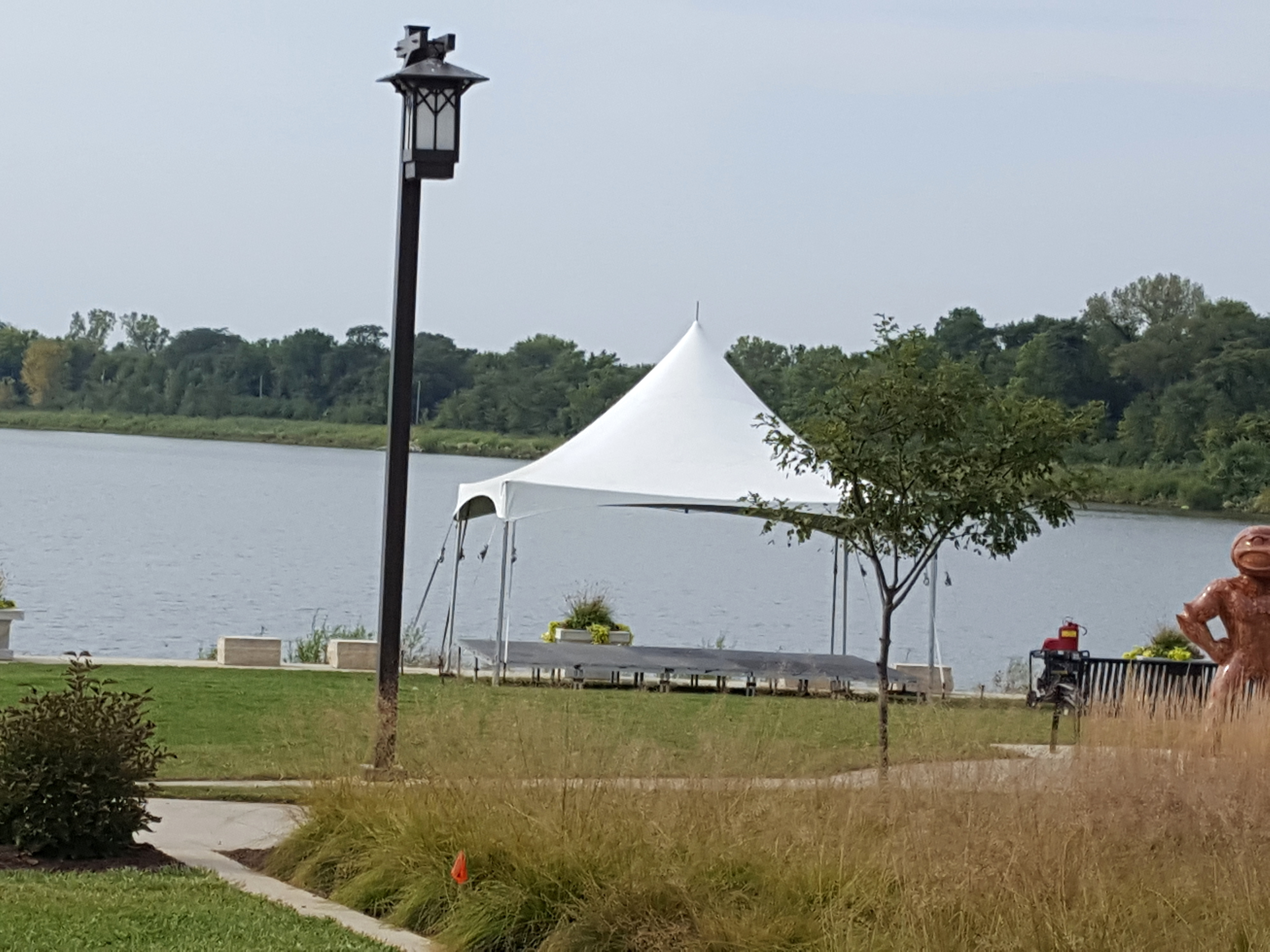 20' x 20' Tentnology tent with stage underneath at Terry Trueblood Recreation Area