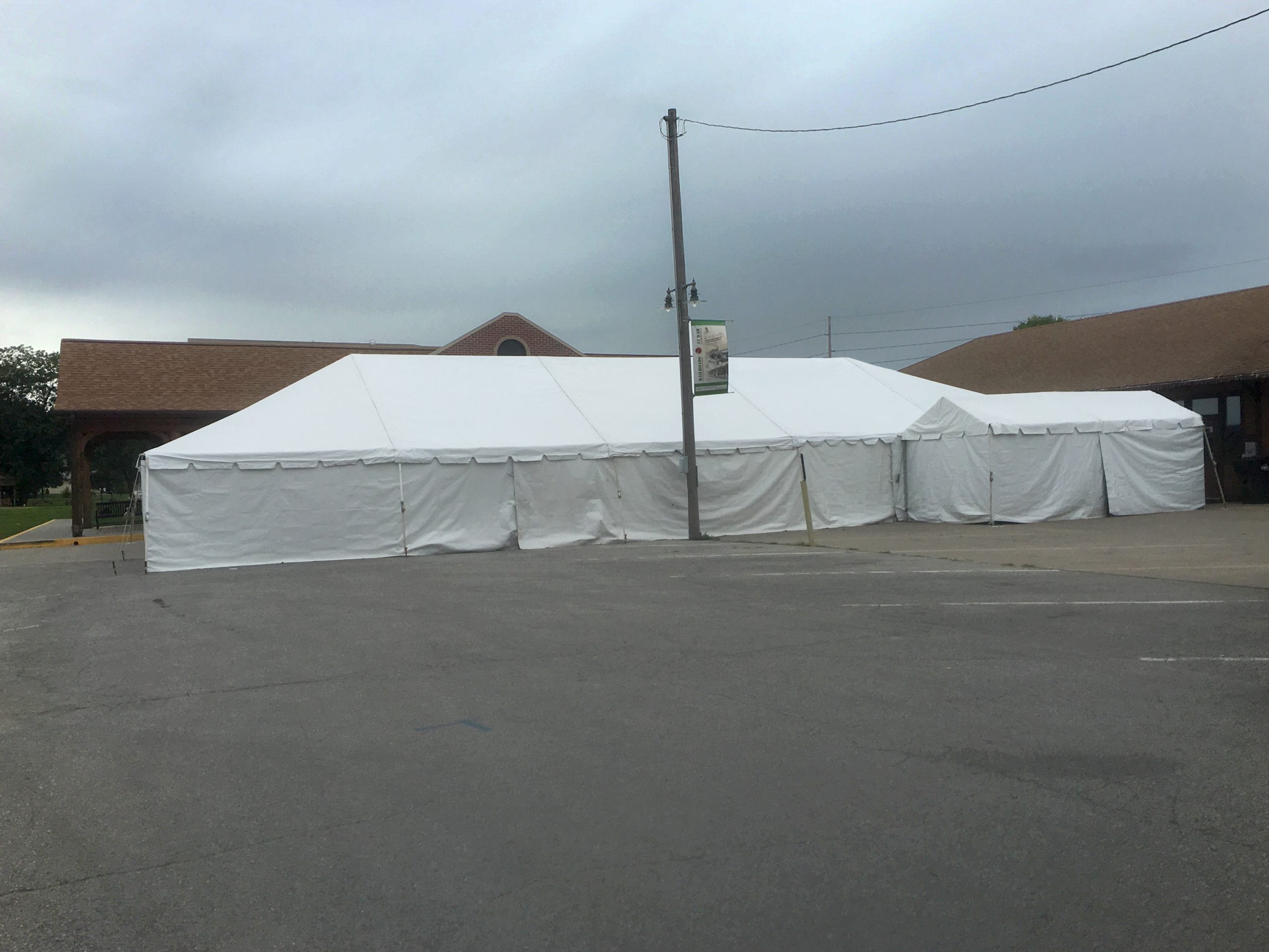 30' x 75' frame tent with 10' x 20' frame tent on the right side both with sidewalls