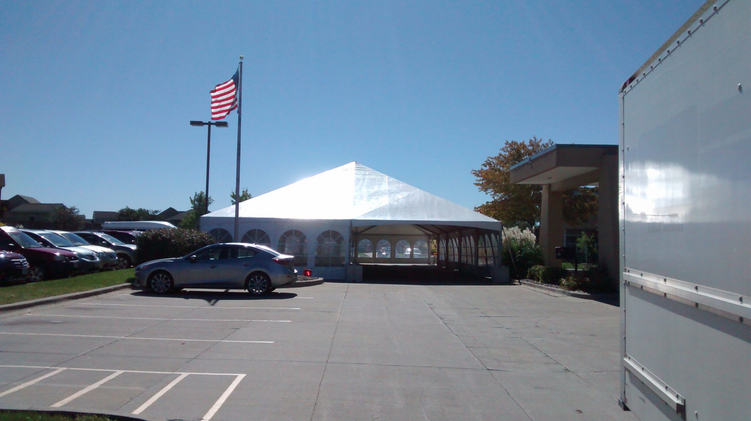 40' x 100' hybrid tent setup in parking lot with 2' x 2' x 2' blocks