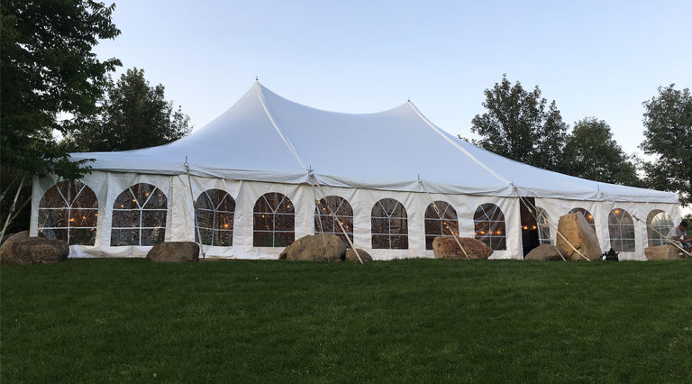 Outdoor tent wedding at Harvest Preserve under a 40′ x 60′ white rope and pole tent