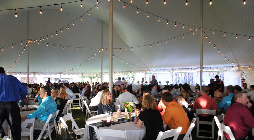 People seated under 60' x 90' rope and pole wedding tent