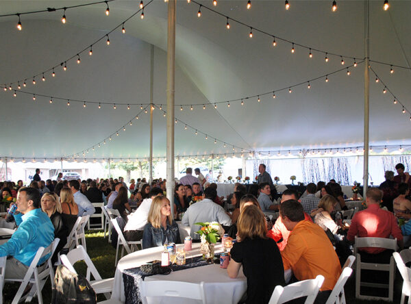 People seated under 60' x 90' rope and pole wedding tent