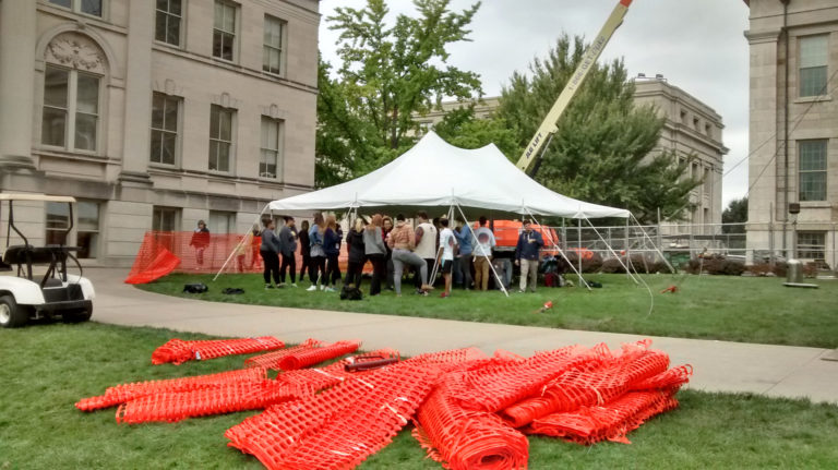 People under 20' x 30' rope and pole tent set up for SCOPE Productions: University of Iowa