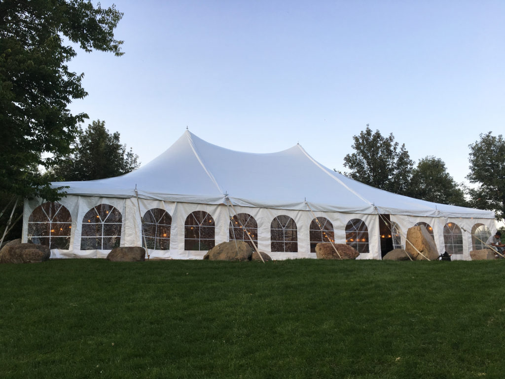 Side view of 40' x 60' white rope and pole wedding tent at Harvest Preserve