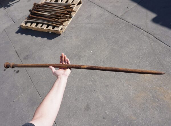 Tent Stake in hand with tent stakess in the background Tent Stake in hand with tent stakess in the background