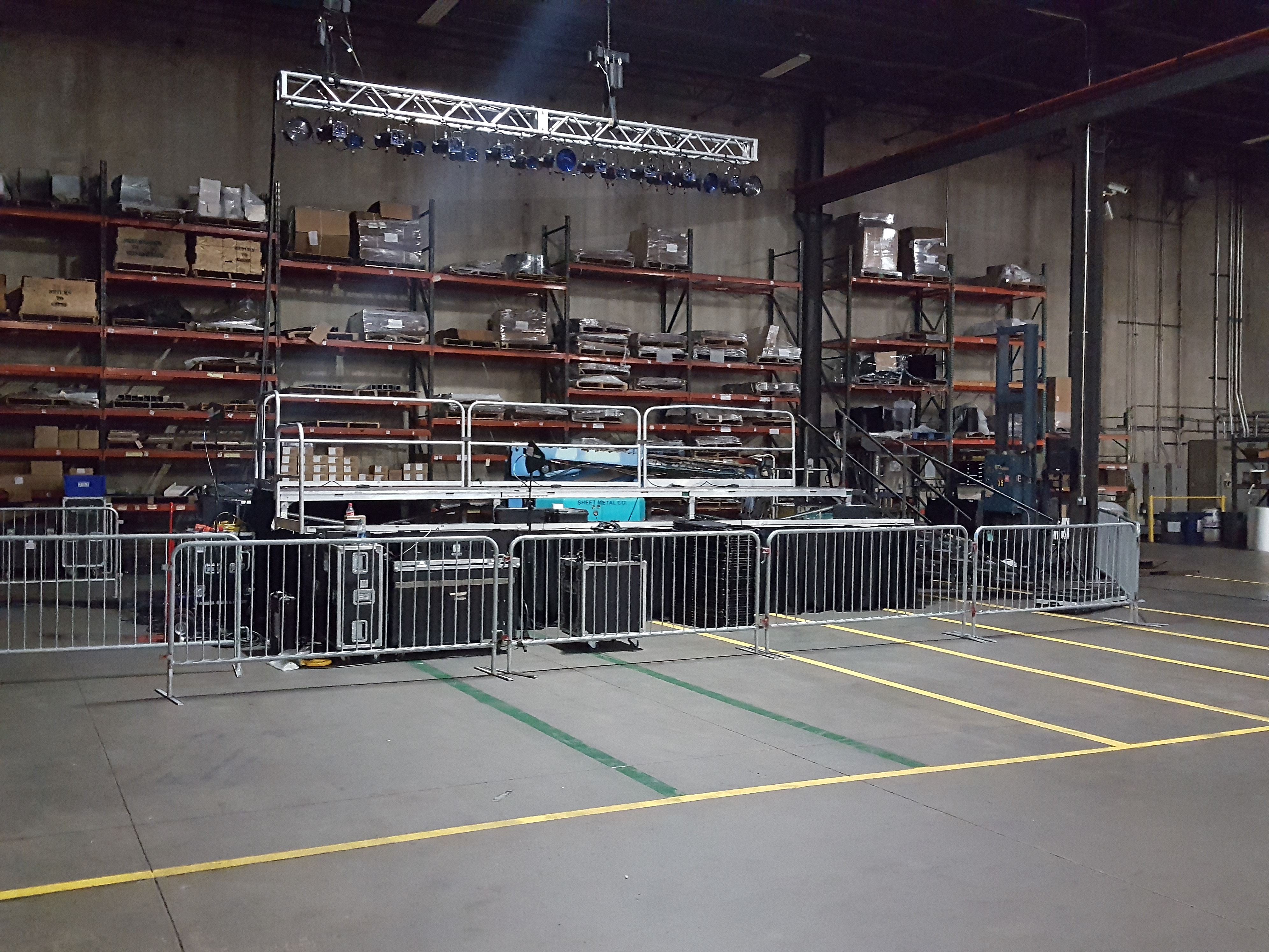 Tiered stage and barricade for political event at Giese Manufacturing being setup