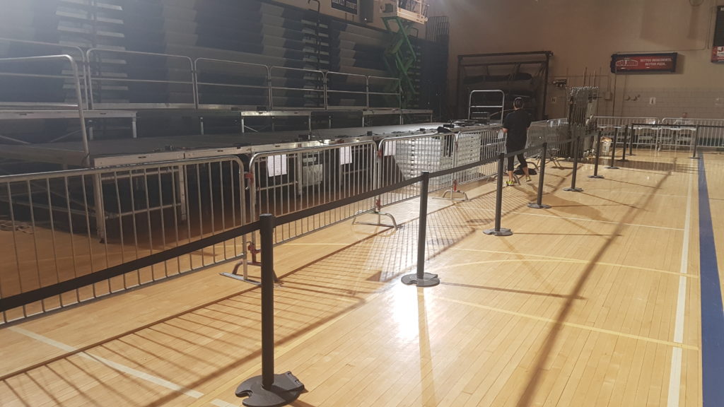 Belt style seat belt stanchions, barricade and stage at political rally