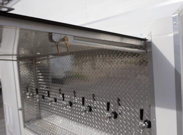 Detail of raised tapper door on the new 6 Tap, 30 Keg, refrigerated draft beer trailer for rent