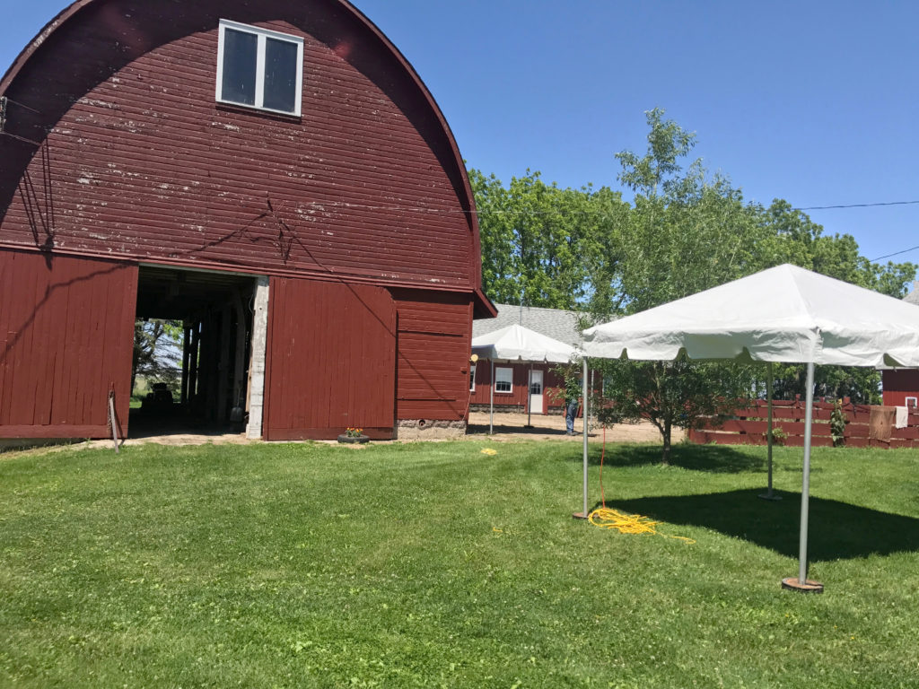 10' x 10' frame tent by a red barn for an outdoor wedding in New Liberty Road, Walcott, IA