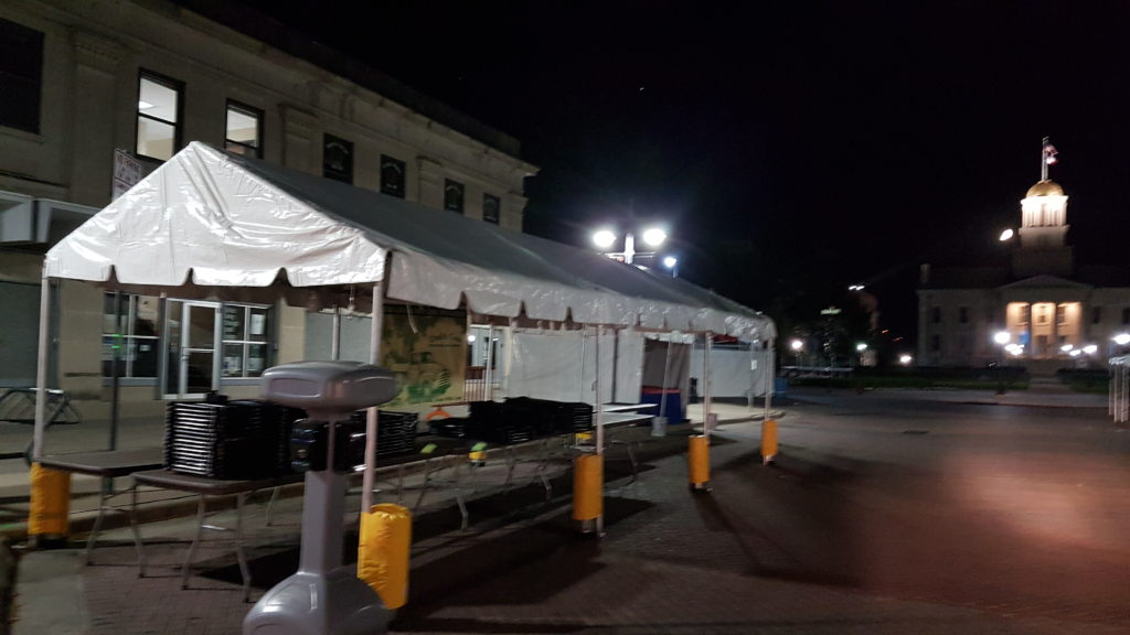 10' x 30' frame tent set up at night for an event