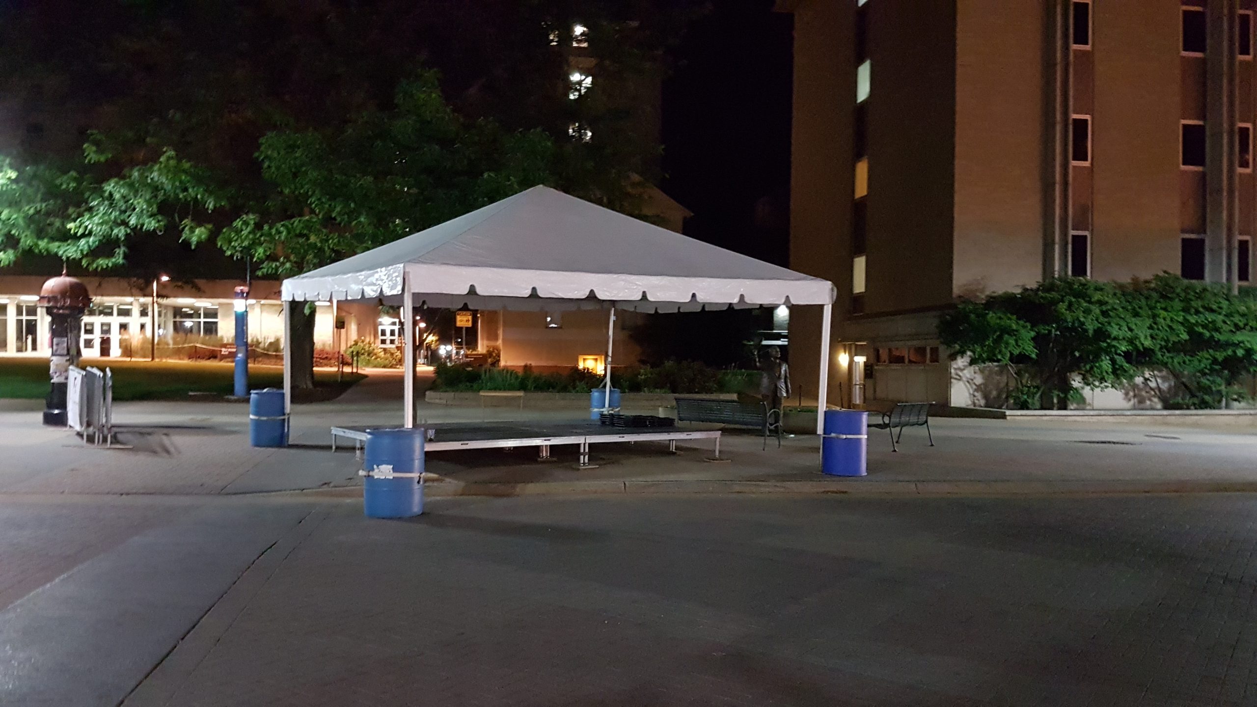 20' x 20 frame tent with stage set up at night