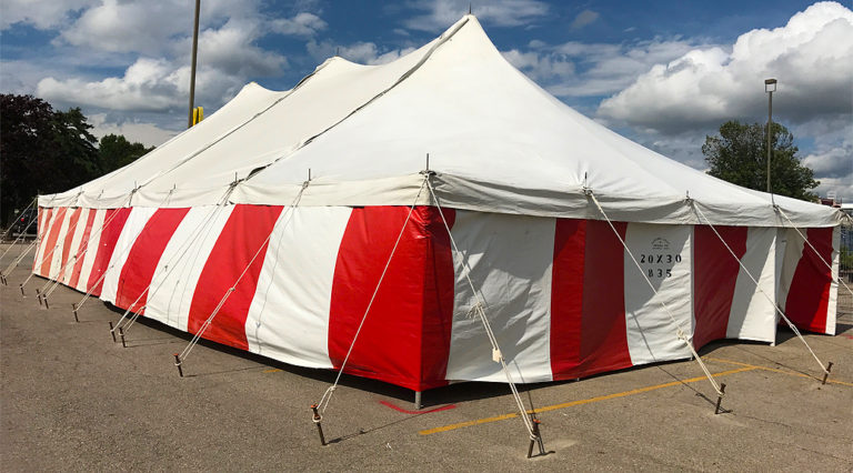 30' x 60' rope and Pole tent with red and white side walls for a Fireworks tent atHy-Vee in Davenport, Iowa