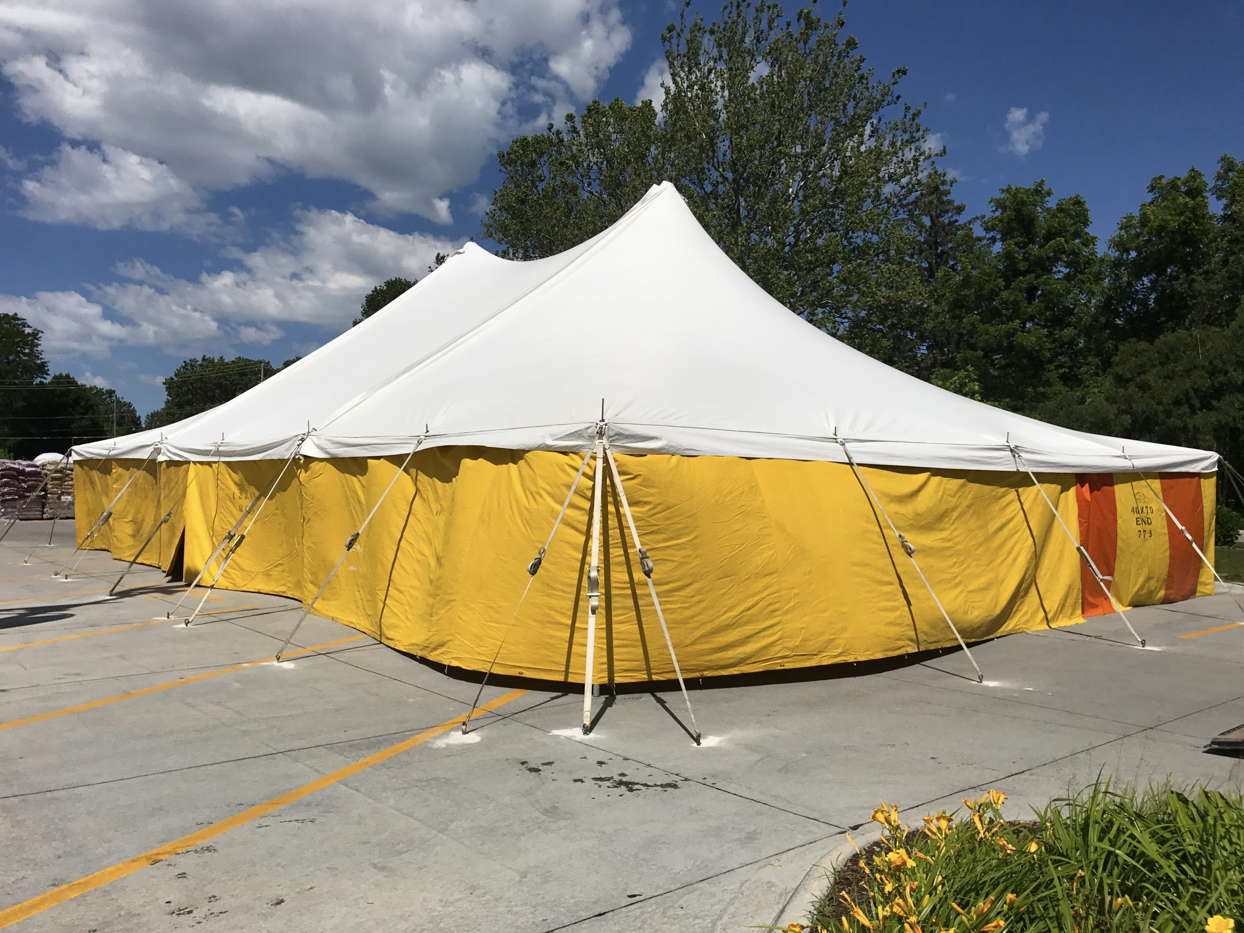 40' x 60' rope and pole fireworks tent with yellow sidewalls at HyVee on Dodge St. in Iowa City for Bellino Fireworks