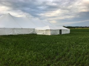 80' x 150' rope and pole tent with a 20' x 60' frame tent with a glass door connected by a 10' x 10' frame tent