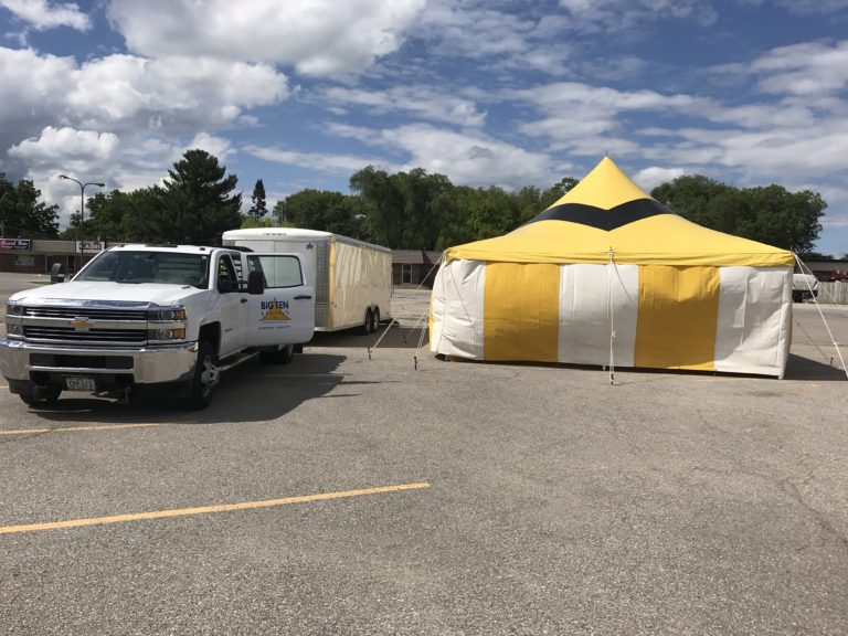 Big Ten Rentals sets up a 20' x 40' rope and pole fireworks tent for Ka-Boomers Fireworks at Maple Lanes Bowling Center in Waterloo, Iowa