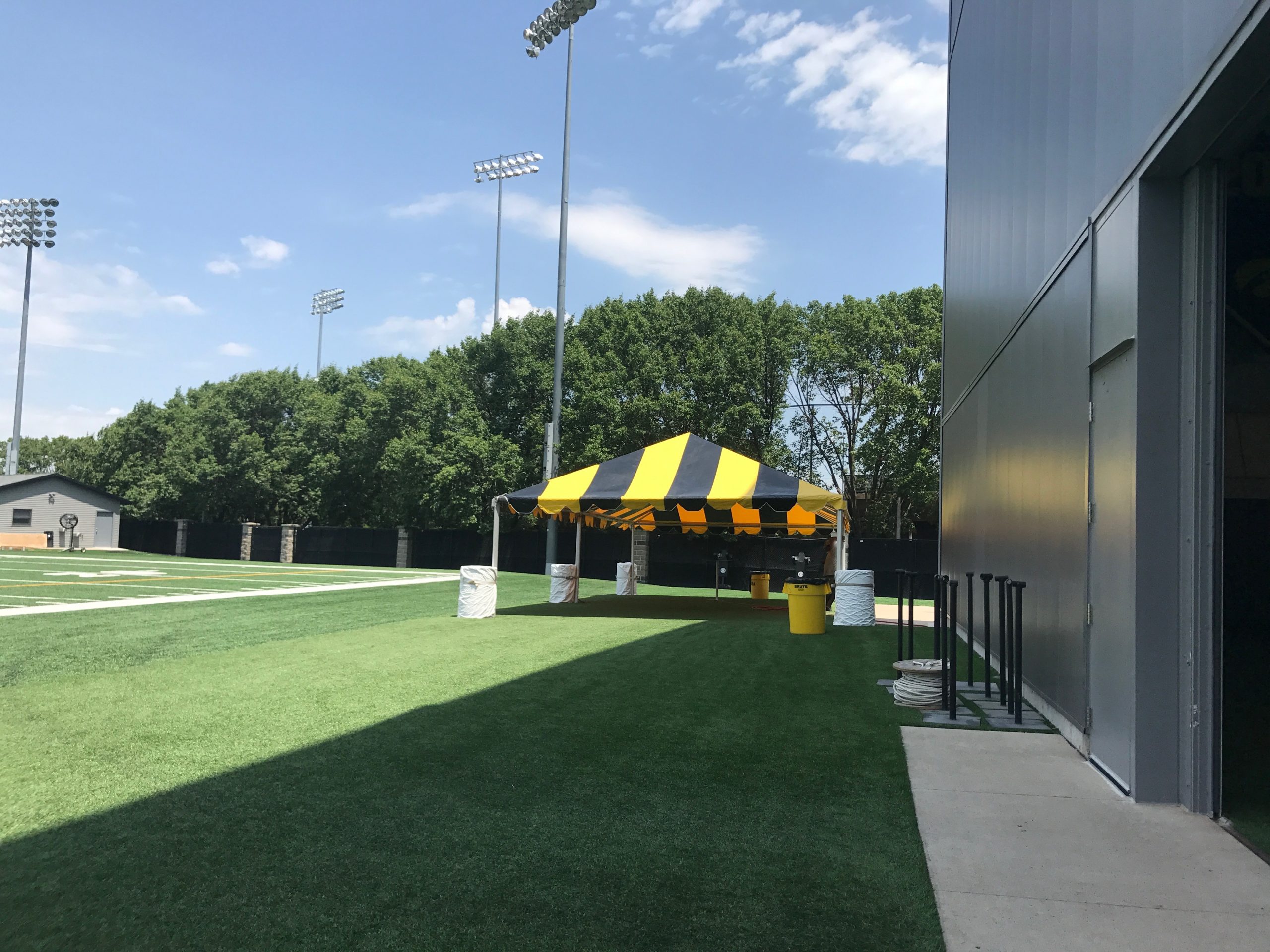 Black and Gold tent for the Ladies Football Academy at the University of Iowa by the football training field