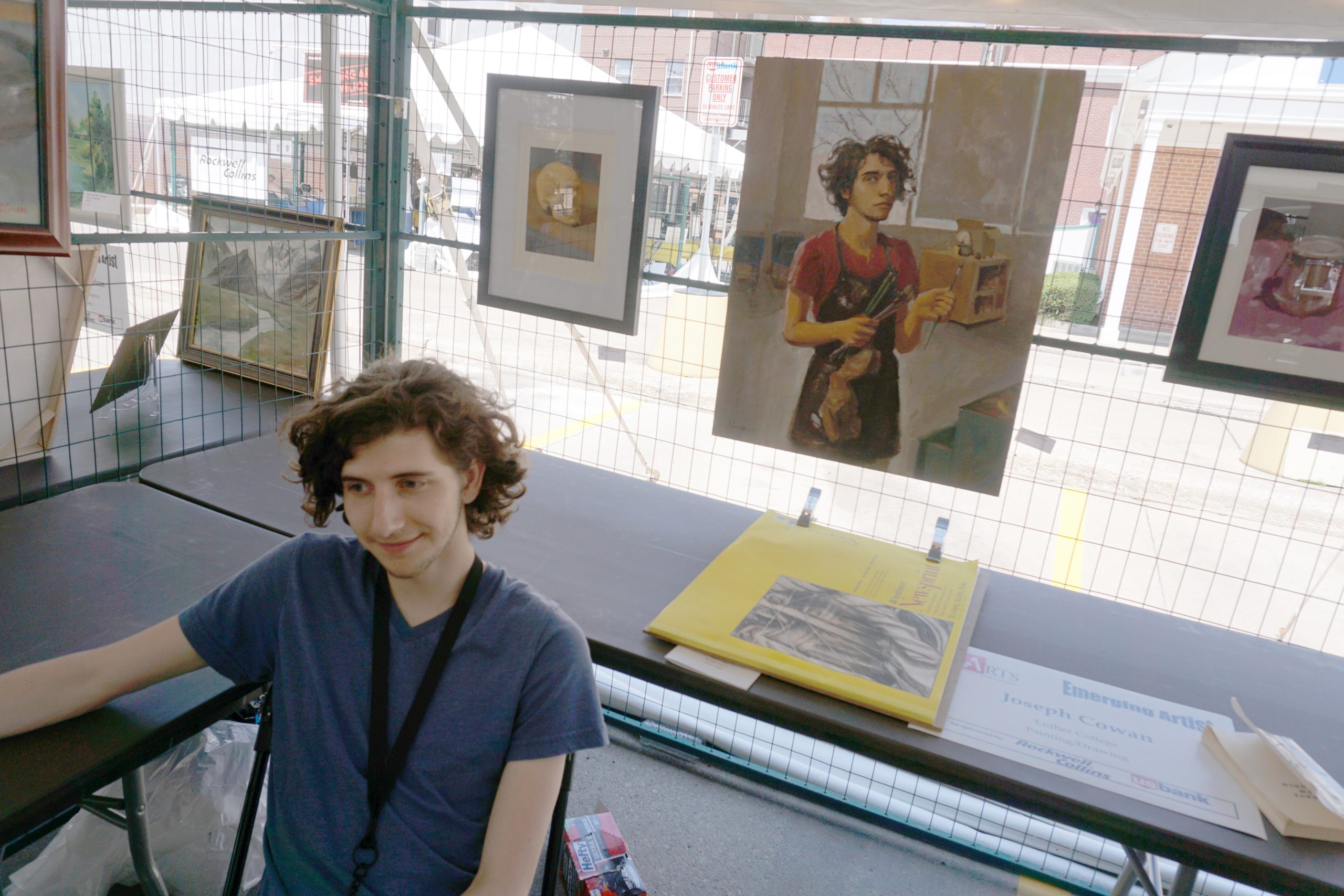 Emerging Artist Joseph Cowan with his self-portrait at the Summer of the Arts Festival