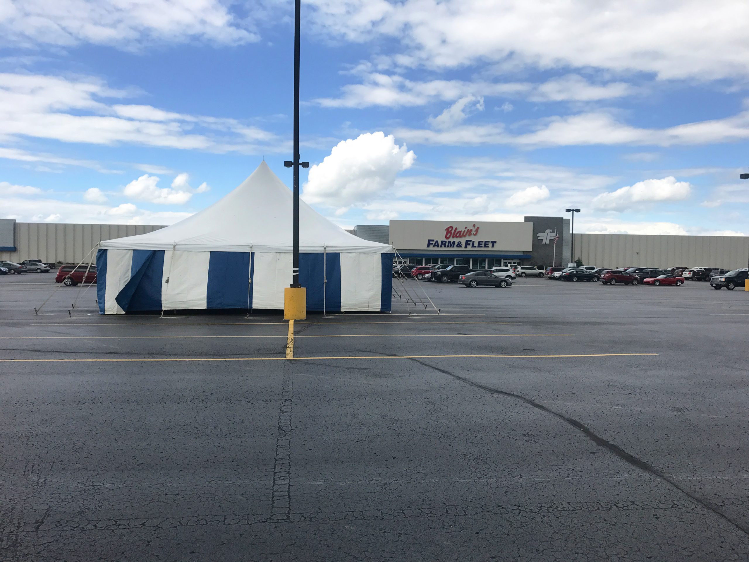 30' x 60' rope and pole tent with blue and white sidewall for Ka-Boomers Fireworks stand in Cedar Falls, Iowa