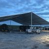 Last minute construction site setup 18m x 20m (60′ x 66)’ Clearspan Tent at dusk