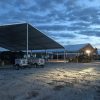 Last minute construction site setup with a 18m x 20m (60′ x 66)’ Clearspan Tent on the left and a 40′ x 60′ Clearspan Tent on the right at dusk