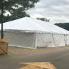 Outside of a 30' x 60' frame tent with white sidewalls for a fireworks stand at Hy-Vee in Cedar Rapids, IA