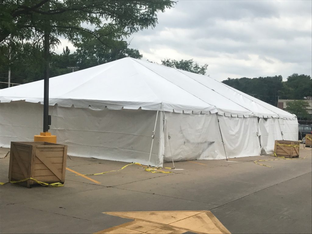 Outside of a 30' x 60' frame tent with white sidewalls for a fireworks stand at Hy-Vee in Cedar Rapids, IA