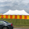 Outside the 30' x 60' rope and pole tent at Hy-Vee 1823 E Kimberly Rd in Davenport, Iowa with Yellow and Orange side walls